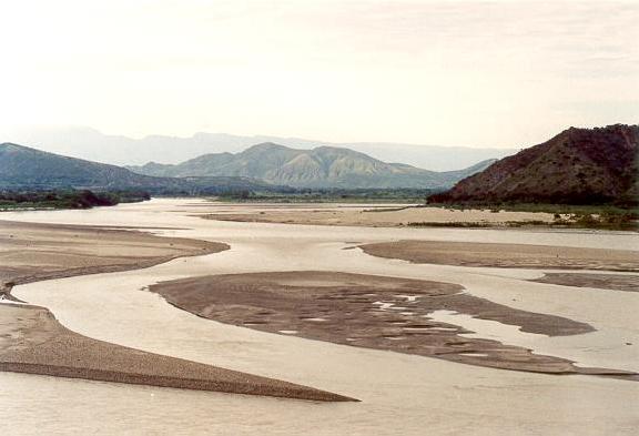 Confluence of Rio Utcubamba (left) and Rio Chinchipe (right) with the Rio Maraon (center right) 20 km north of Bagua, Amazonas, Peru (2003). 