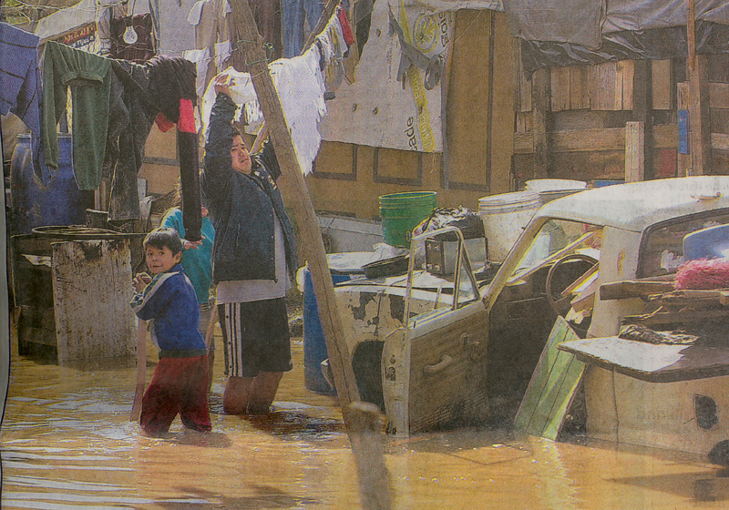 Residents of Arroyo Alamar, Tijuana, stood in waters that flooded their homes