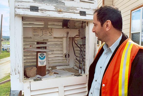 Hamzeh Ramadan inspecting temperature gage at Campo valley, San Diego County.