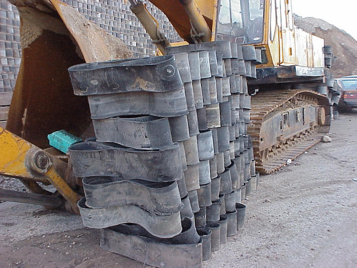 Discarded tires ready to be used in constructing retaining wall.